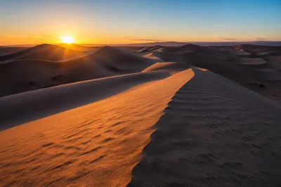 Golden Sunset Over Sweeping Desert Dunes