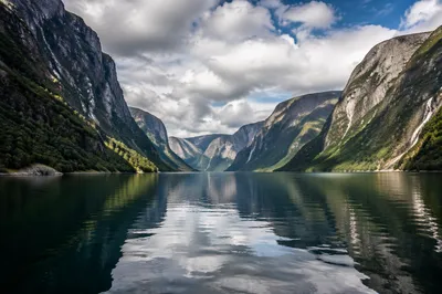 Serene Norwegian Fjord With Steep Granite Cliffs