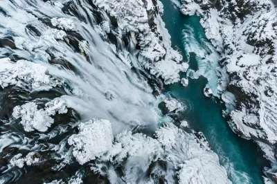 Frozen Waterfall Over Turquoise Glacial Gorge