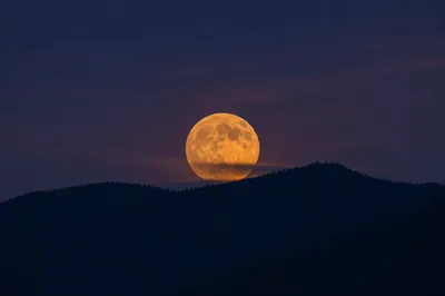 Amber Full Moon Over Mountain Silhouette