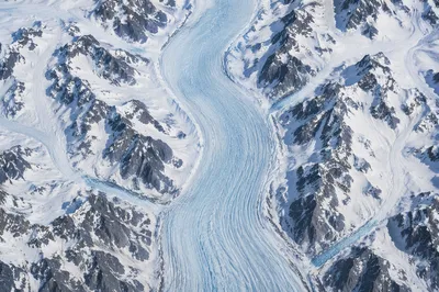 Remote Blue Glacier Through Snowy Mountains