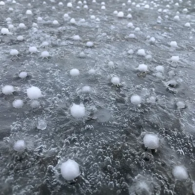 Hailstones on Frozen Surface After Storm