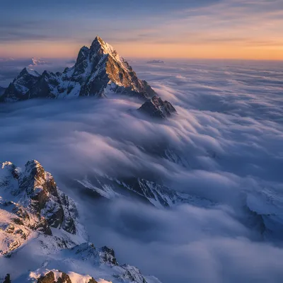 Majestic Mountain Peak Above Ocean Clouds