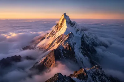 Majestic Mountain Peak Above Sunrise Clouds