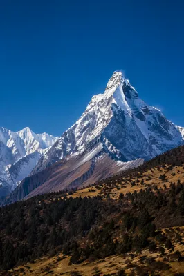 Snow-Capped Mountain Peak Under Blue Sky