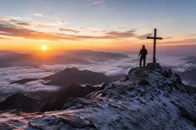 Climber Near Summit Cross at Sunrise