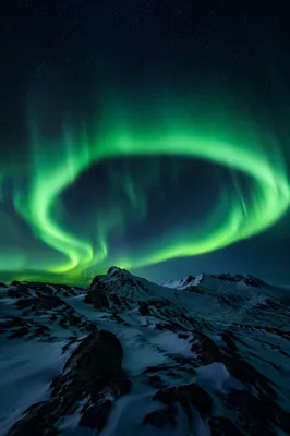 Green Aurora Over Snowy Polar Mountains