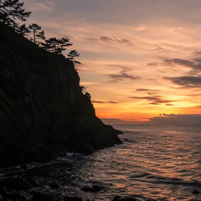Silhouetted Coastal Cliffs at Golden Sunset
