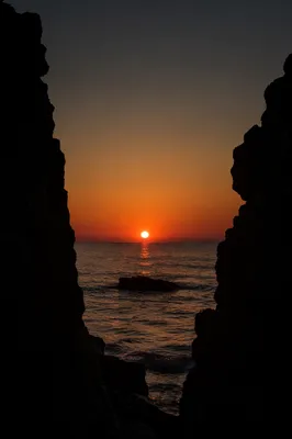 Ocean Sunset Framed by Sea Cliffs