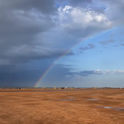 Rainbow Over Sandy Plain After Rain