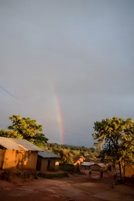 Faint Rainbow Over Rural Sky After Rain