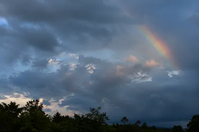 Soft Rainbow Over Rainy Evening Sky