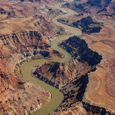 Aerial River Curves Through Desert Canyon