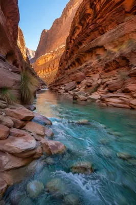 Turquoise River Through Sunlit Canyon Rocks