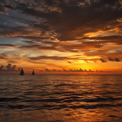 Peaceful Sailboats on Ocean Sunset Horizon