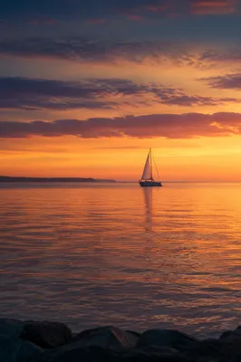 Peaceful Sailboat on Ocean Sunset Horizon