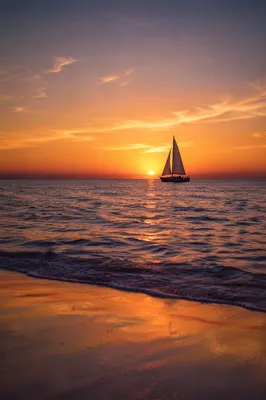 Peaceful Sailboat at Ocean Sunset