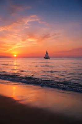 Peaceful Sailboat at Ocean Sunset