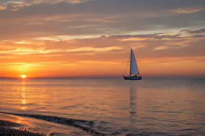 Peaceful Sailboat on Ocean at Sunset