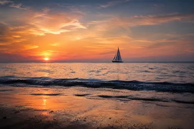 Peaceful Sailboat at Ocean Sunset