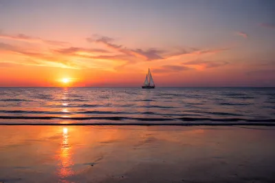 Peaceful Sailboat at Ocean Sunset Shoreline