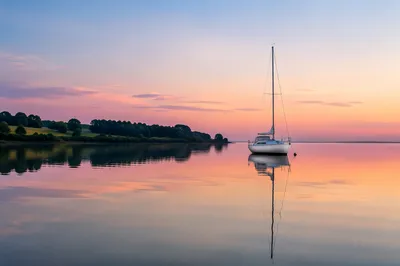 Calm Sailboat Sunset Reflection on Lake