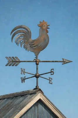 Rustic Rooster Weather Vane Against Blue Sky