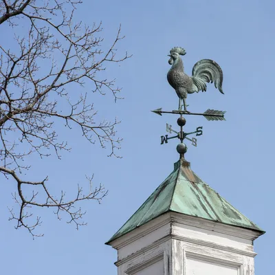 Antique Rooster Weather Vane Against Blue Sky