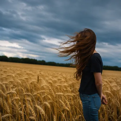 Contemplative Figure in Windblown Golden Wheat