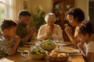 African American Family Praying at Dinner Table