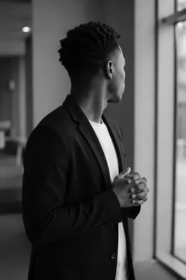 Reflective Young Adult by Tall Window