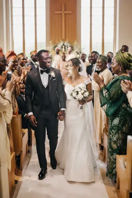 African Newlyweds Walking Down Church Aisle