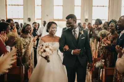 African Newlyweds Walking Down Church Aisle