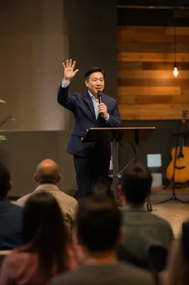 Asian Pastor Preaching on Modern Church Stage