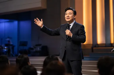 Asian Pastor Preaching on Modern Church Stage