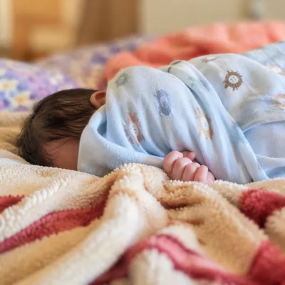 Peaceful Newborn Sleeping in Blue Swaddle