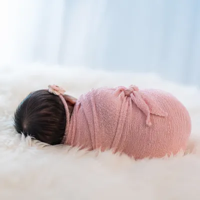 Peaceful Sleeping Newborn in Pink Swaddle