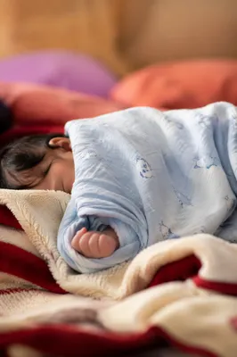 Peaceful Newborn Sleeping in Blue Swaddle