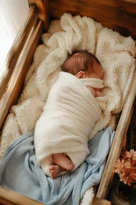 Peaceful Newborn Sleeping in Wooden Cradle