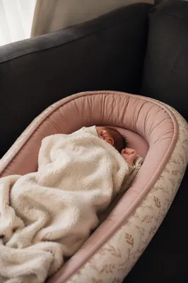 Peaceful Newborn Sleeping in Cream Blanket