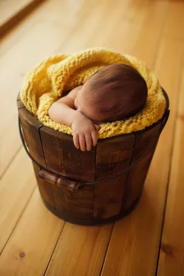 Sleeping Newborn in Yellow Knitted Blanket