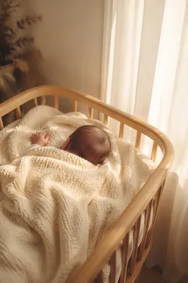 Peaceful Newborn Sleeping in Cream Blanket