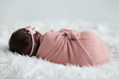 Peaceful Newborn Sleeping in Pink Swaddle