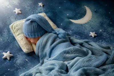 Peaceful Sleeping Newborn in Blue Blanket