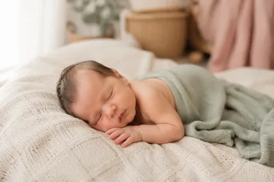Sleeping Newborn on Knit Blanket