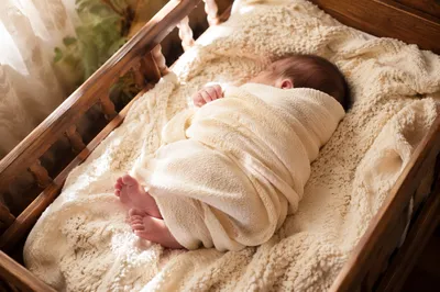 Peaceful Newborn Sleeping in Rustic Cradle