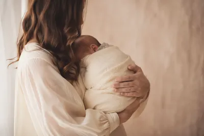 Peaceful Newborn Cradled in Ivory Blanket