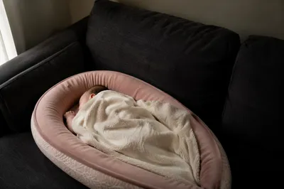 Peaceful Newborn Sleeping in Cream Blanket