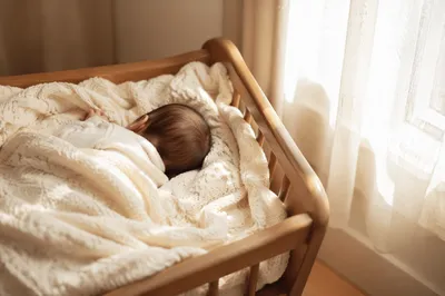 Peaceful Newborn Sleeping in Cream Blanket