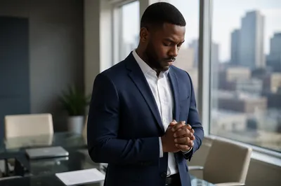 Businessman Praying in Modern Office Room